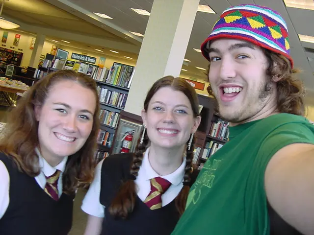 In the image there is a man and two students taking a selfie and it looks like they are standing in...