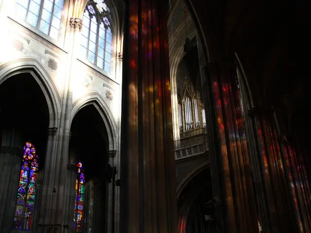 There are buildings with windows. On the windows there are painting.